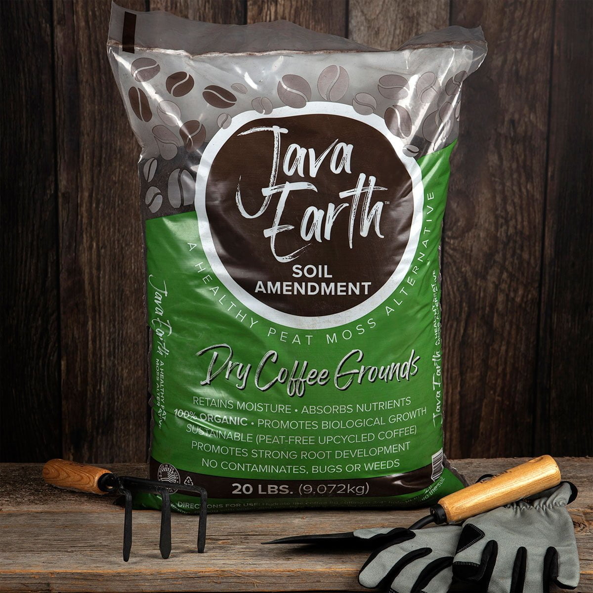 Bag of JavaEarth Soil Amendment on a wooden table with garden tools arranged in front of it